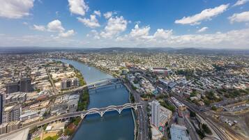 An aerial view of a city with a river, bridges, and dense urban development.