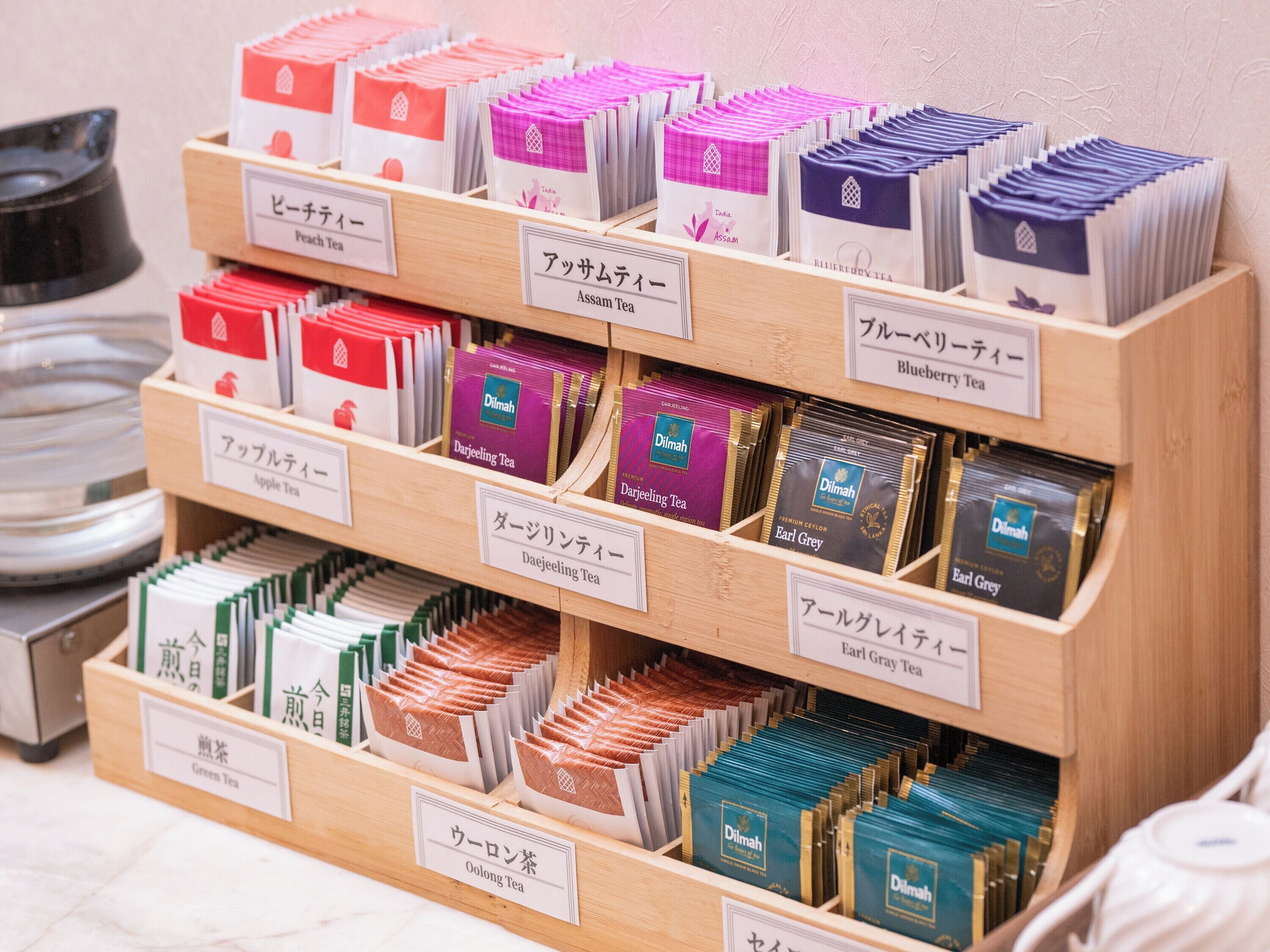 A display of tea varieties with labels in a wooden case.