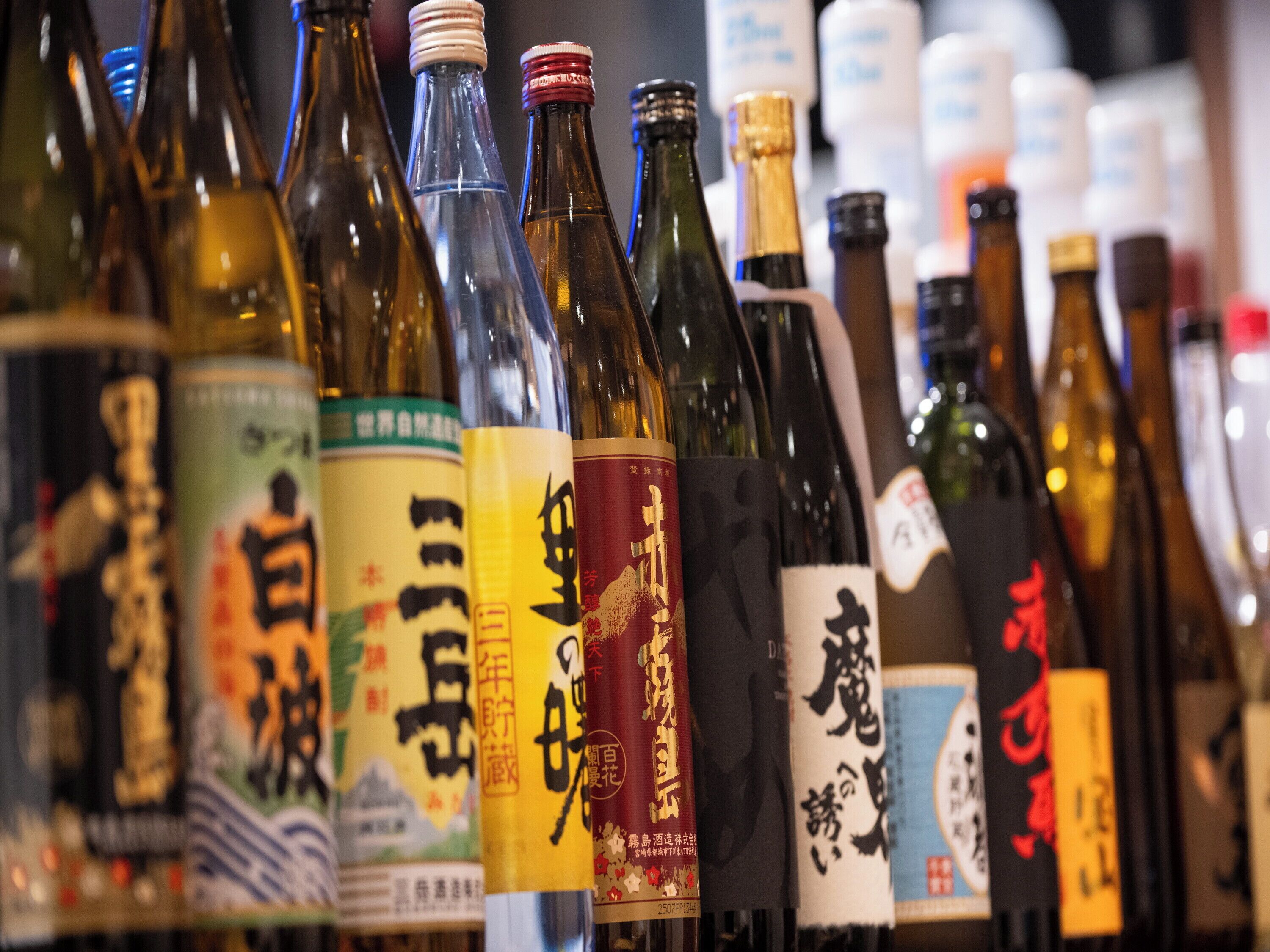 A variety of bottles with labels, likely containing beverages.