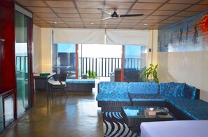 Two bed room family suite with balcony | Living area | Flat-screen TV, pay films