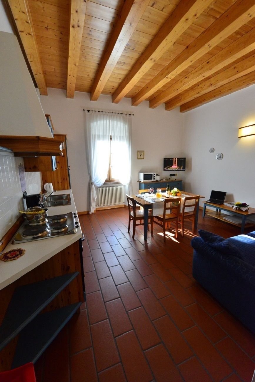 A compact kitchen with a stove, microwave, and dining table.
