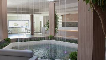 Experience serenity in this modern space featuring a central water feature and minimalist design.