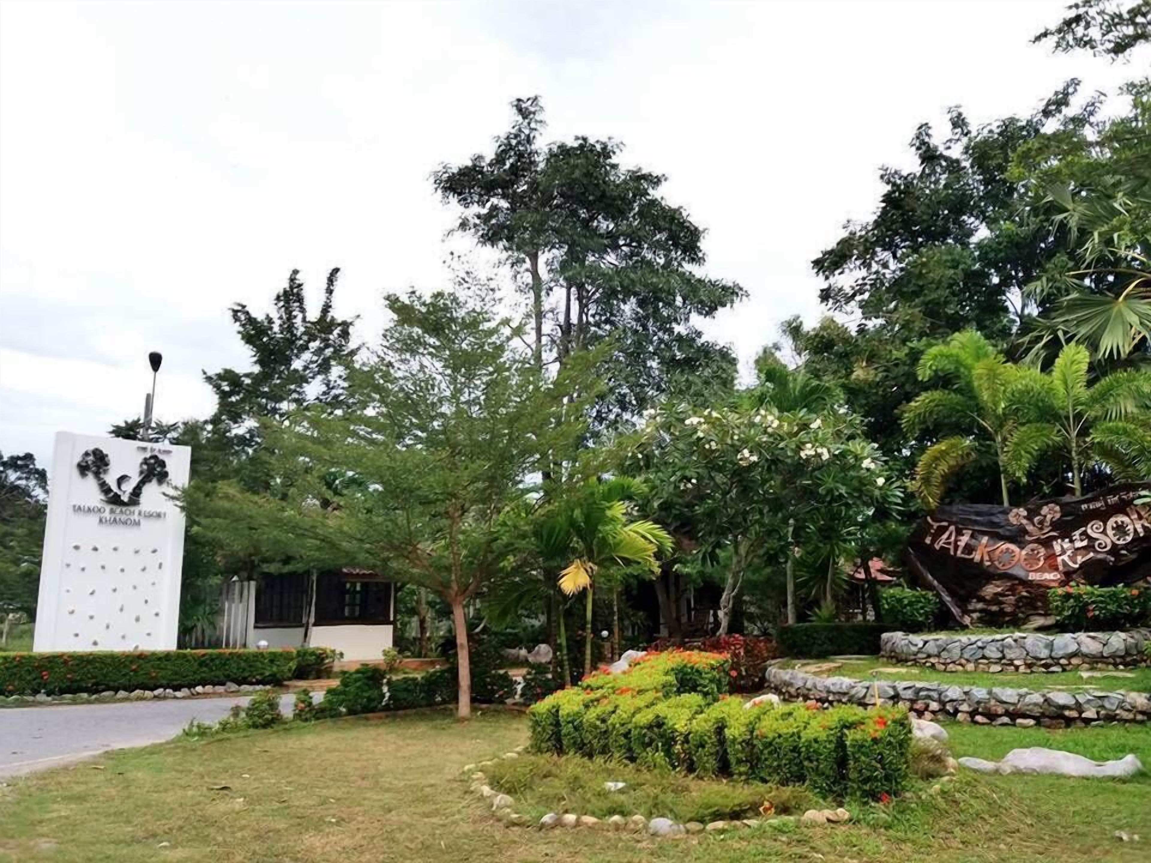 A sign for Taloyo Beach Resort with a calendar and a decorative signboard.