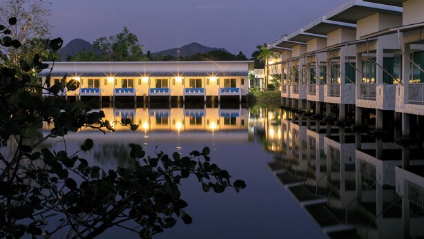 A hotel with a pool reflecting the building and a mountain in the background. - Anavilla Tangke Resort (Khanom)