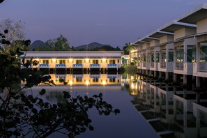 A hotel with a pool reflecting the building and a mountain in the background. - Anavilla Tangke Resort (Khanom)