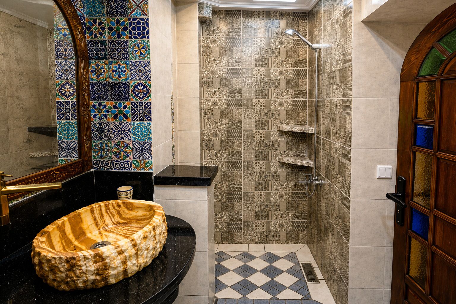 A bathroom with a marble sink, a shower with patterned tiles, and a wooden door with glass panels.