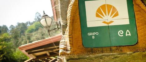 A Grupo B CA sign on a stone wall.