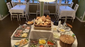 A buffet setup with various food items and a view of the dining area. - Wärdshuset Furuliden (Vittsjo)