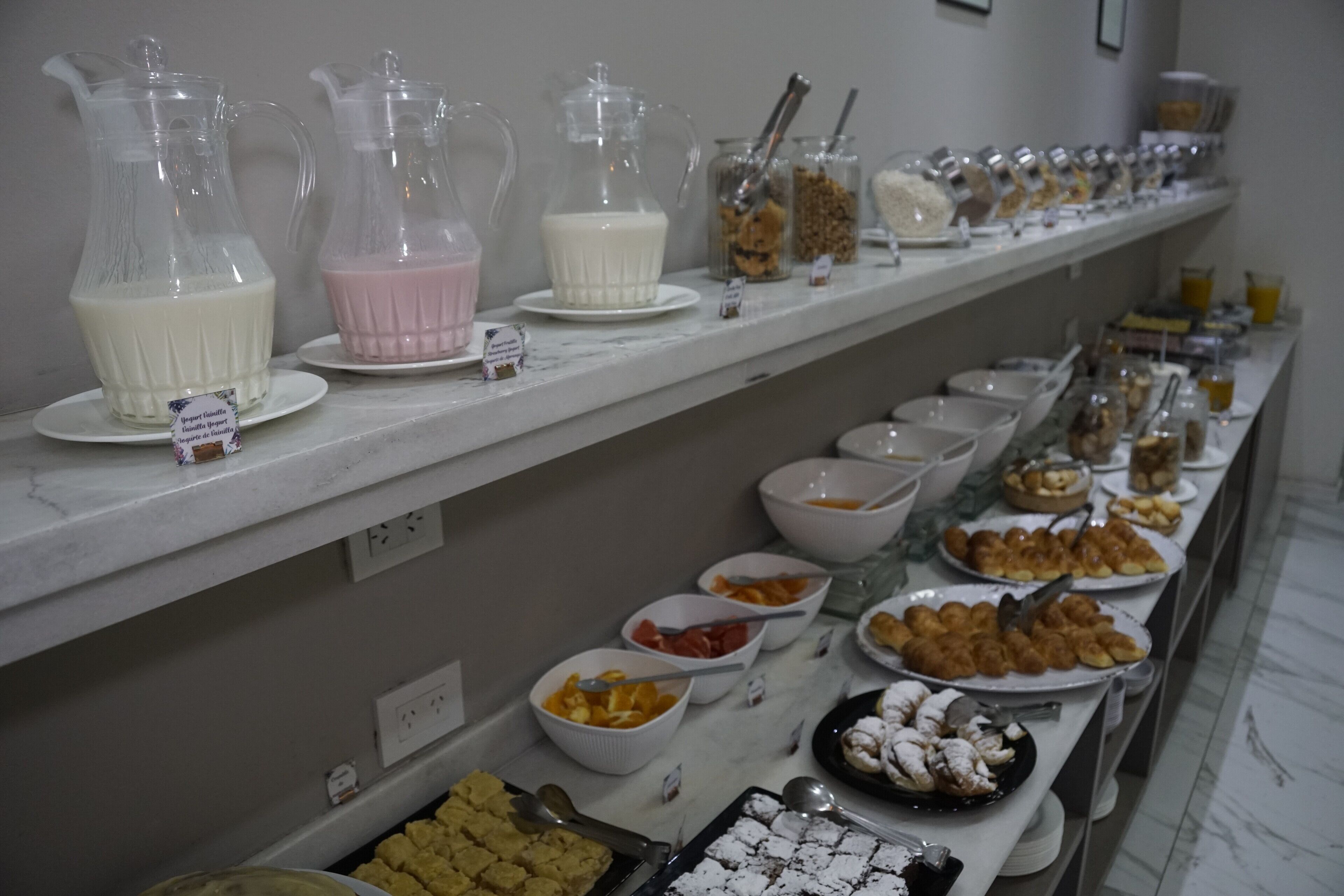 A buffet with various food items and beverages.