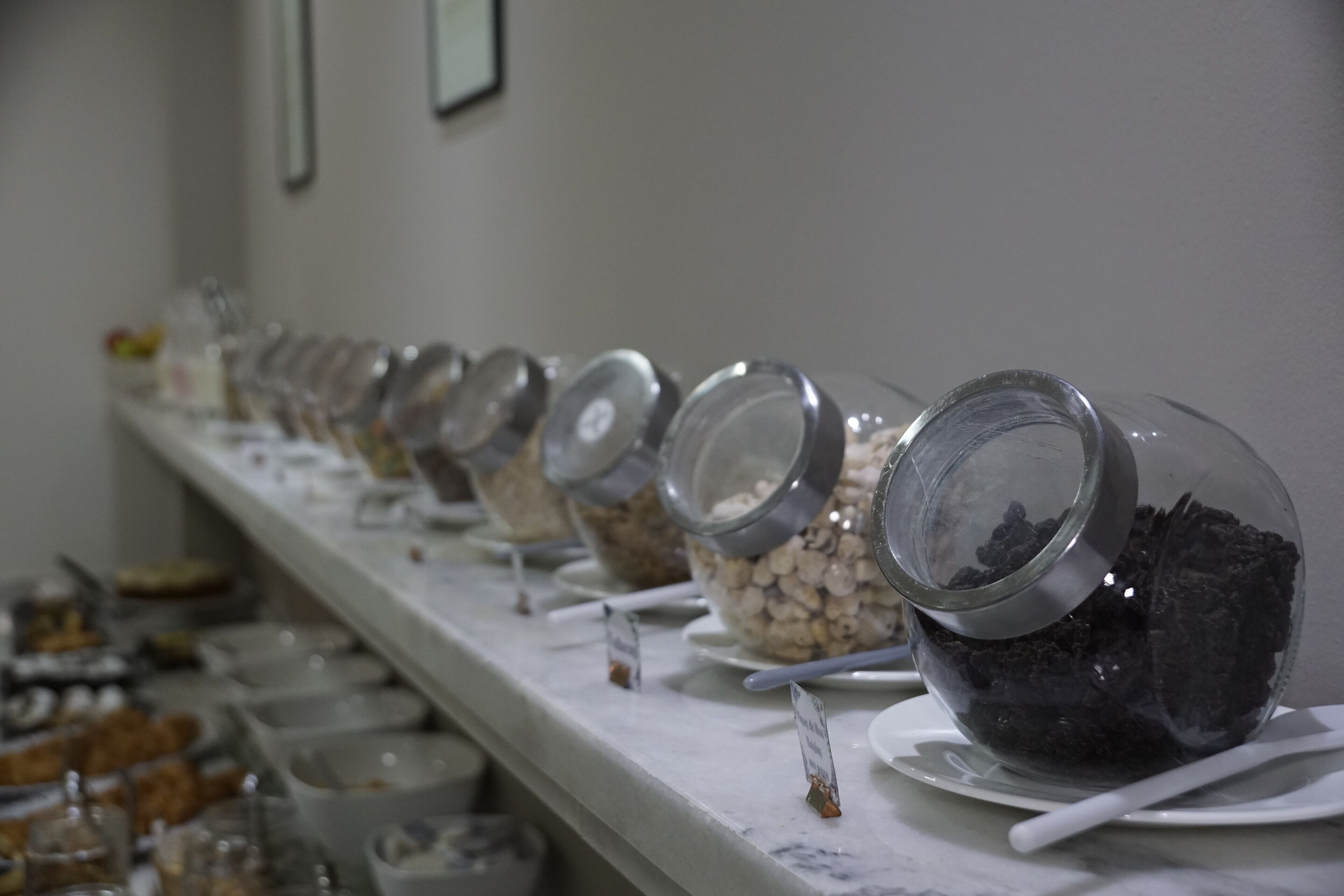 A buffet line with various food items and containers.