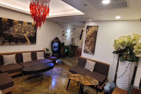 A modern living room with a sectional sofa, a round coffee table, and a fireplace.