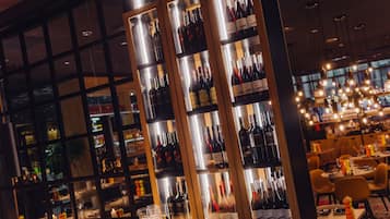 A bar area with shelves of wine bottles and glasses.