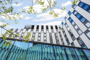 A modern building with a glass facade and a sign reading 'CLARION HOTEL.' - Clarion Hotel Aviapolis (Vantaa)