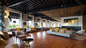 A spacious living area with multiple seating options, a fireplace, and large windows providing natural light. - 250 Main Hotel (Rockland)