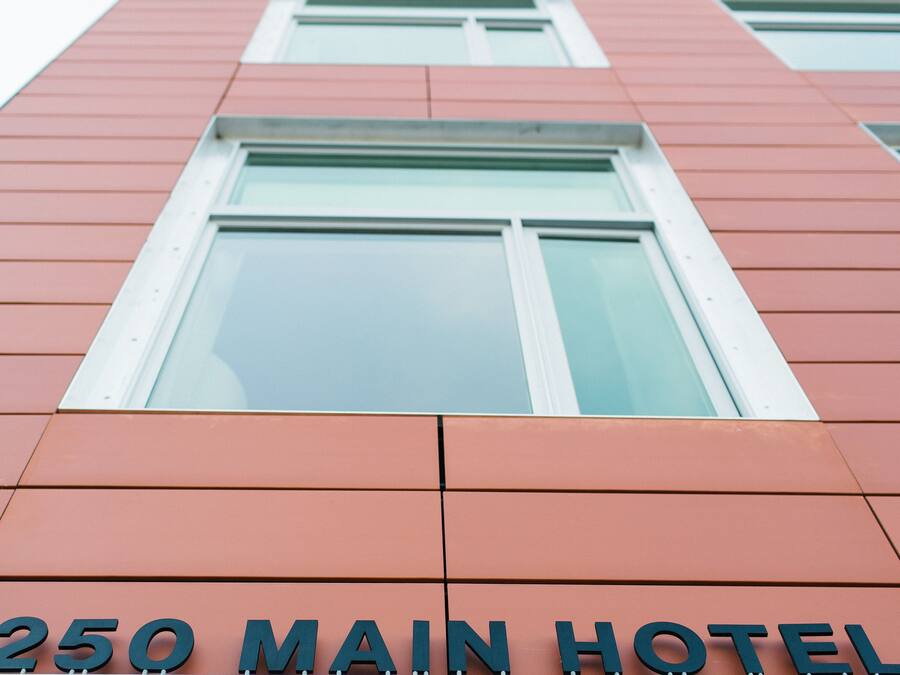 A building with a sign reading "250 MAIN HOTEL".