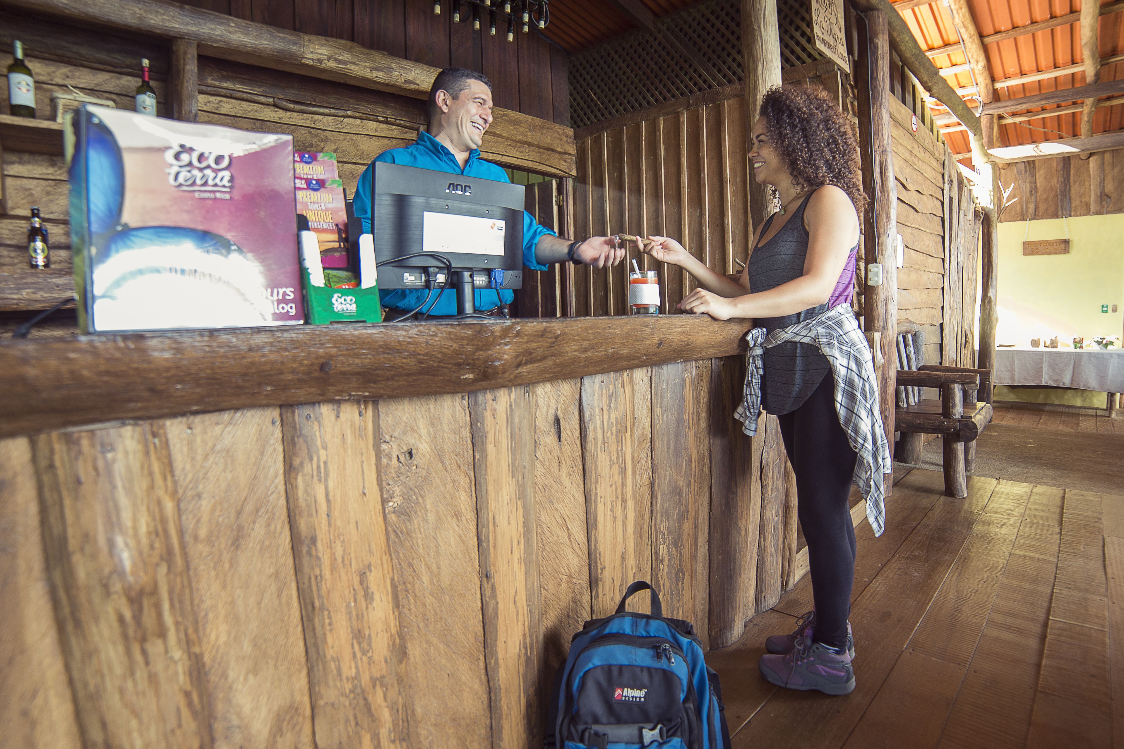 A wooden reception desk with a coffee machine and a box labeled "Eco Terra."