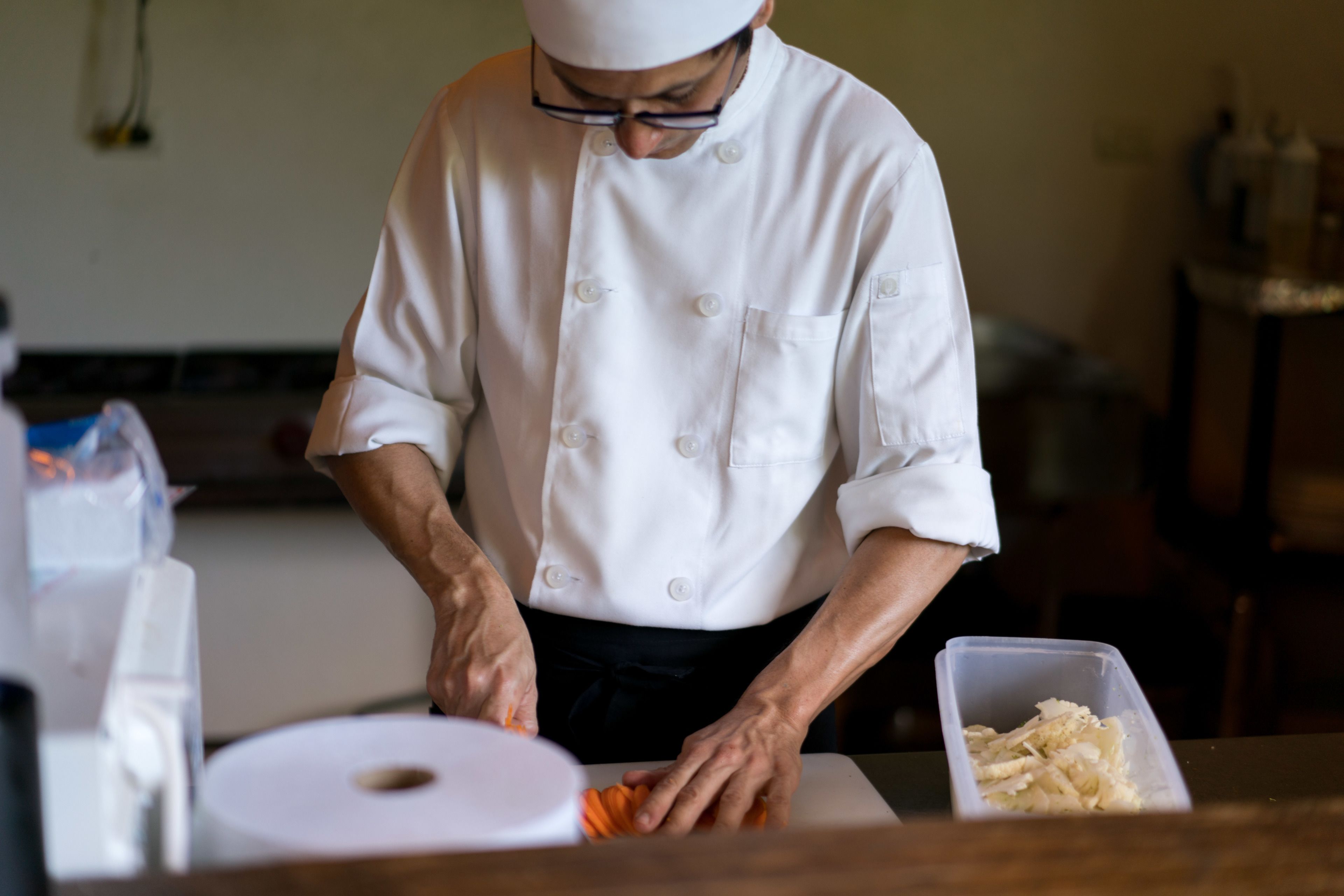A chef preparing food in a kitchen.