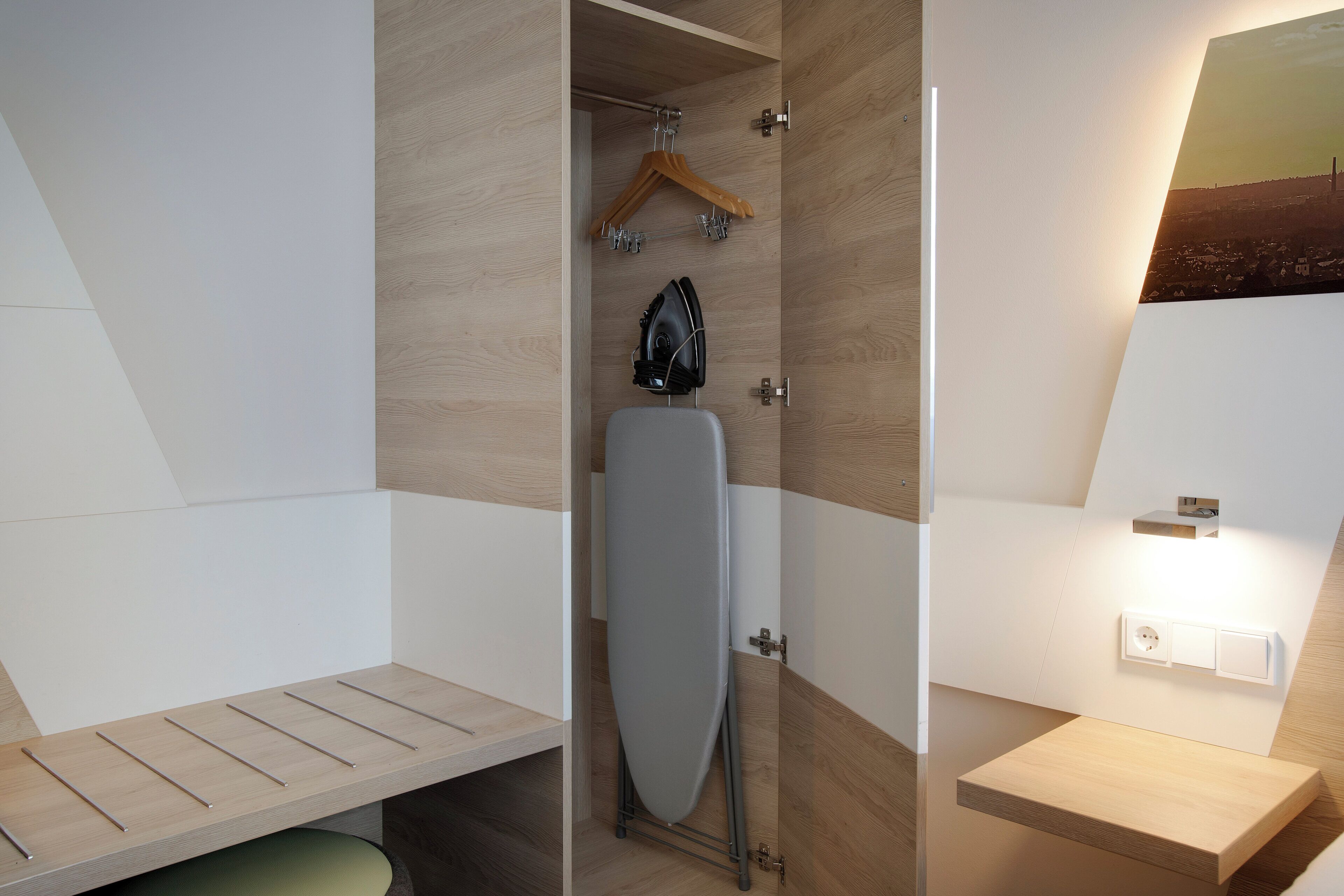 A modern bathroom with a shower, a towel rack, and a mirror.