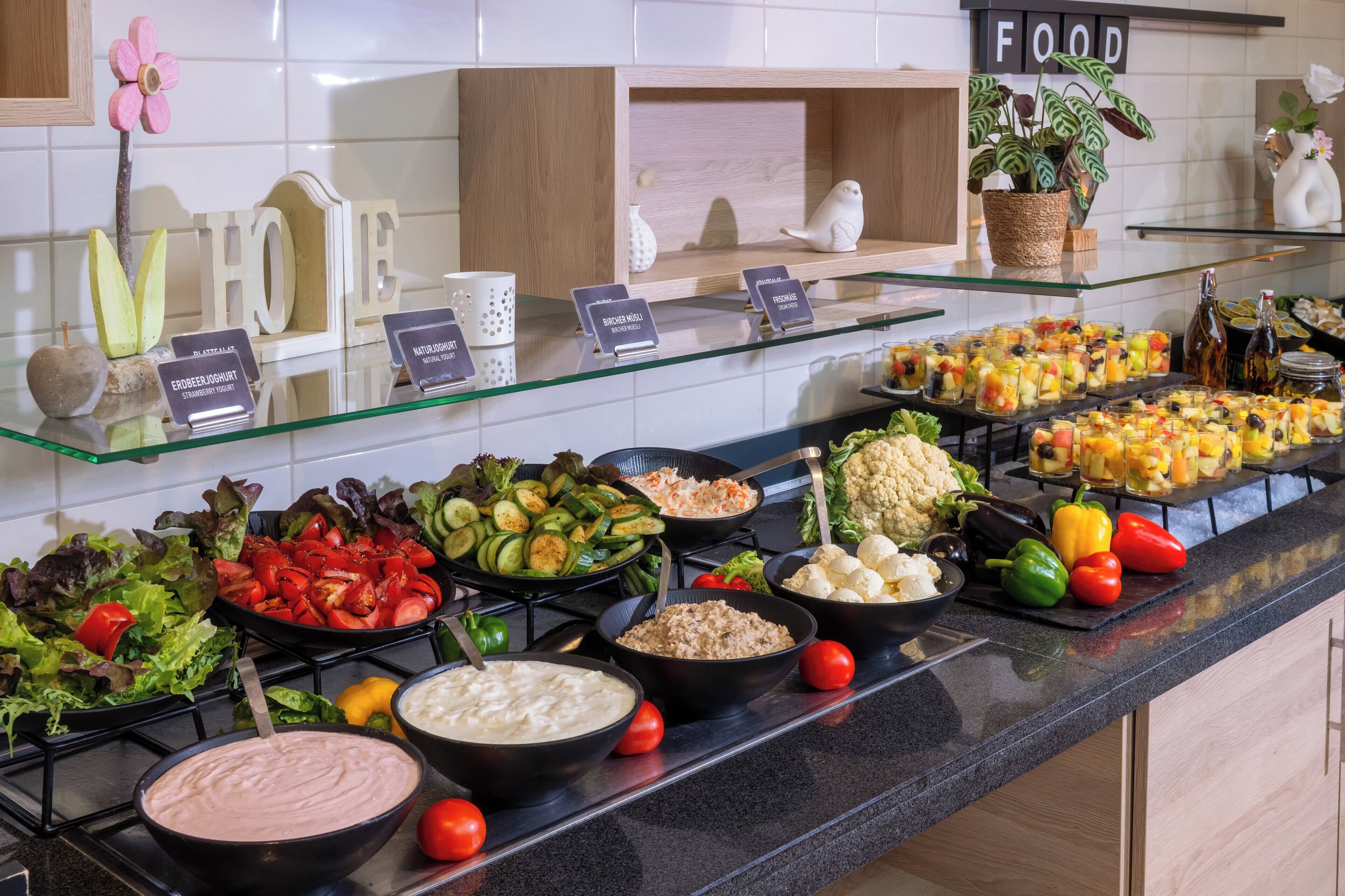 A buffet with various food items and a sign that reads 'FOOD'.