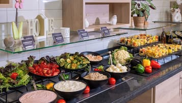 A buffet with various food items and a sign that reads 'FOOD'.