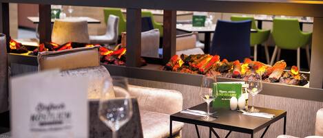 A restaurant setting with a table set for dining, including a menu, a glass of water, and a wine glass.