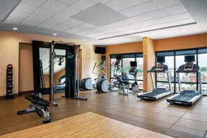 A gym with treadmills, elliptical machines, and weightlifting equipment. - Hilton Garden Inn Mobile Downtown (Mobile)