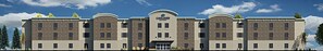 A hotel with a stone facade, multiple balconies, and a central entrance. - Candlewood Suites Lakeville I-35 by IHG (Lakeville)