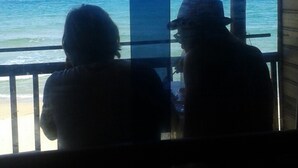 Two people sitting by a window overlooking the ocean. - Dyke rest (Trincomalee)