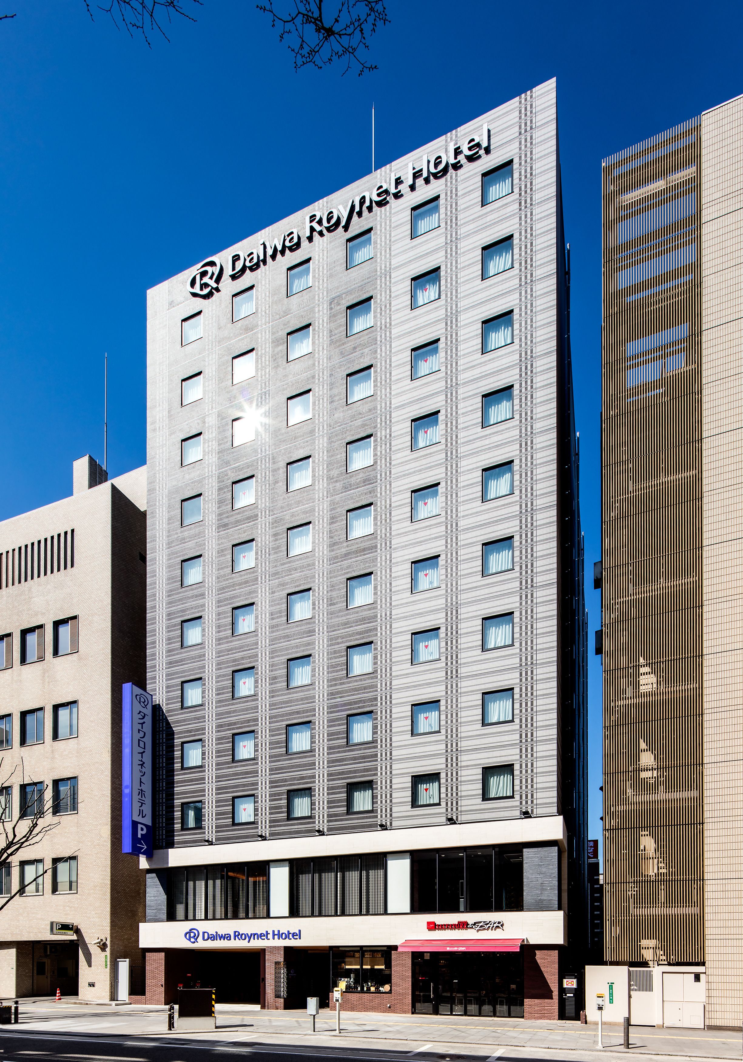 A modern hotel building with a prominent sign for Dalai Roynet Hotel.