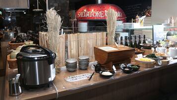 A restaurant counter with a pizza oven, various dishes, and condiments.