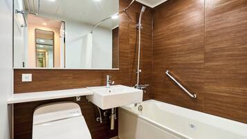 Un baño moderno con inodoro, lavamanos y bañera.