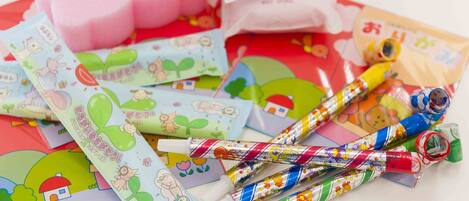 A collection of colorful stationery items, including pens and envelopes, with playful designs and Japanese text.