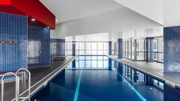 Relax by the pool, surrounded by a clean and well-maintained space with a clear view of the blue tiles.
