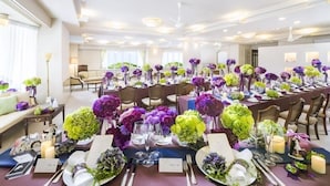 A banquet hall with tables set for a formal event, featuring floral centerpieces and formal table settings. - Hotel Karuizawa Elegance (Karuizawa)