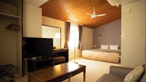 A hotel room with a television, a desk, a sofa, a bed, and a ceiling fan. - Hotel Karuizawa Elegance (Karuizawa)
