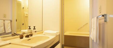 Een badkamer met twee wasbakken, een douche en een bad.