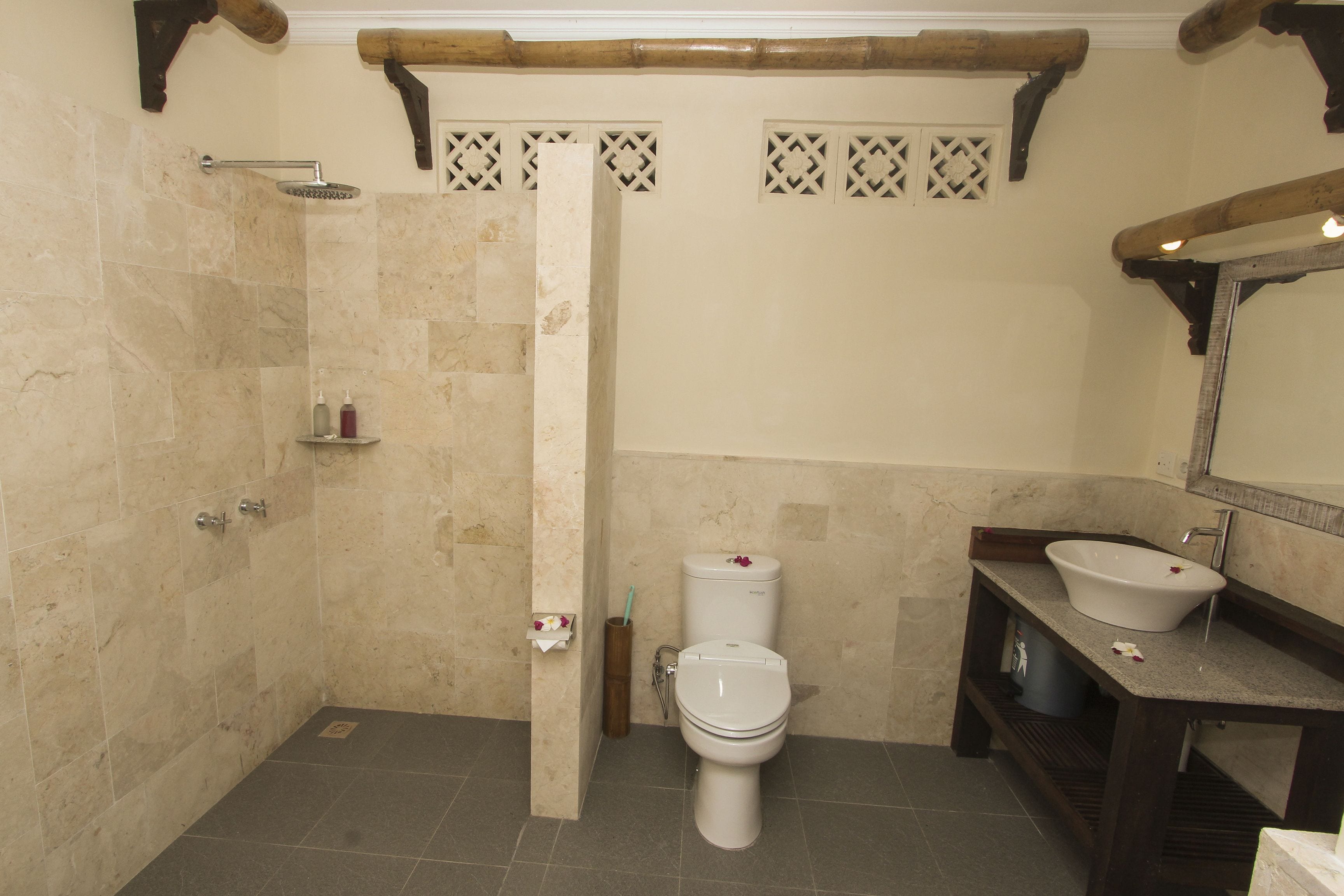 A bathroom with a shower, toilet, and sink.