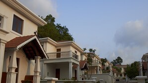 A row of colonial-style buildings with balconies and a paved walkway. - Pinto Rosario Square Resort and Spa (Guirim)