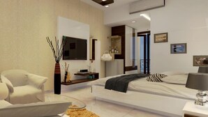 A modern bedroom with a bed, a chair, a glass table, and a mirror. - Rezo's Hotel (Baga)