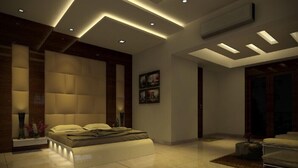 A modern bedroom with a large bed, recessed lighting, and a minimalist design. - Rezo's Hotel (Baga)