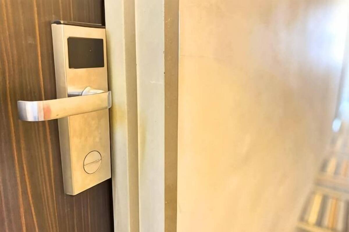 A door with a modern, metallic handle and a keyhole.