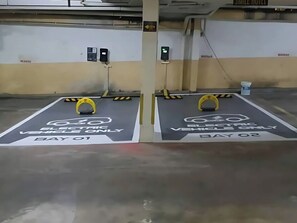 An electric vehicle parking area with two designated spots labeled "Day 01" and "Day 02". - Smile Hotel Wangsa Maju (Kuala Lumpur)
