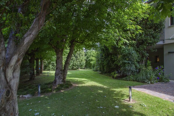 A well-maintained garden with a pathway leading to a building.