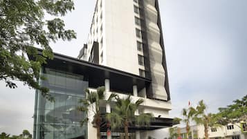 A modern building with a glass facade and a sign for the Brits Hotel.