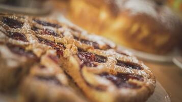 A close-up of pastries with a flaky crust and a filling that appears to be fruit-based, possibly cherry or berry.