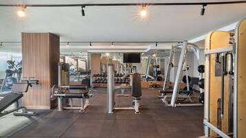 A gym with various exercise equipment, including weight machines and free weights.