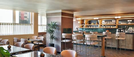 A restaurant with wooden flooring, bar area, and seating arrangements.