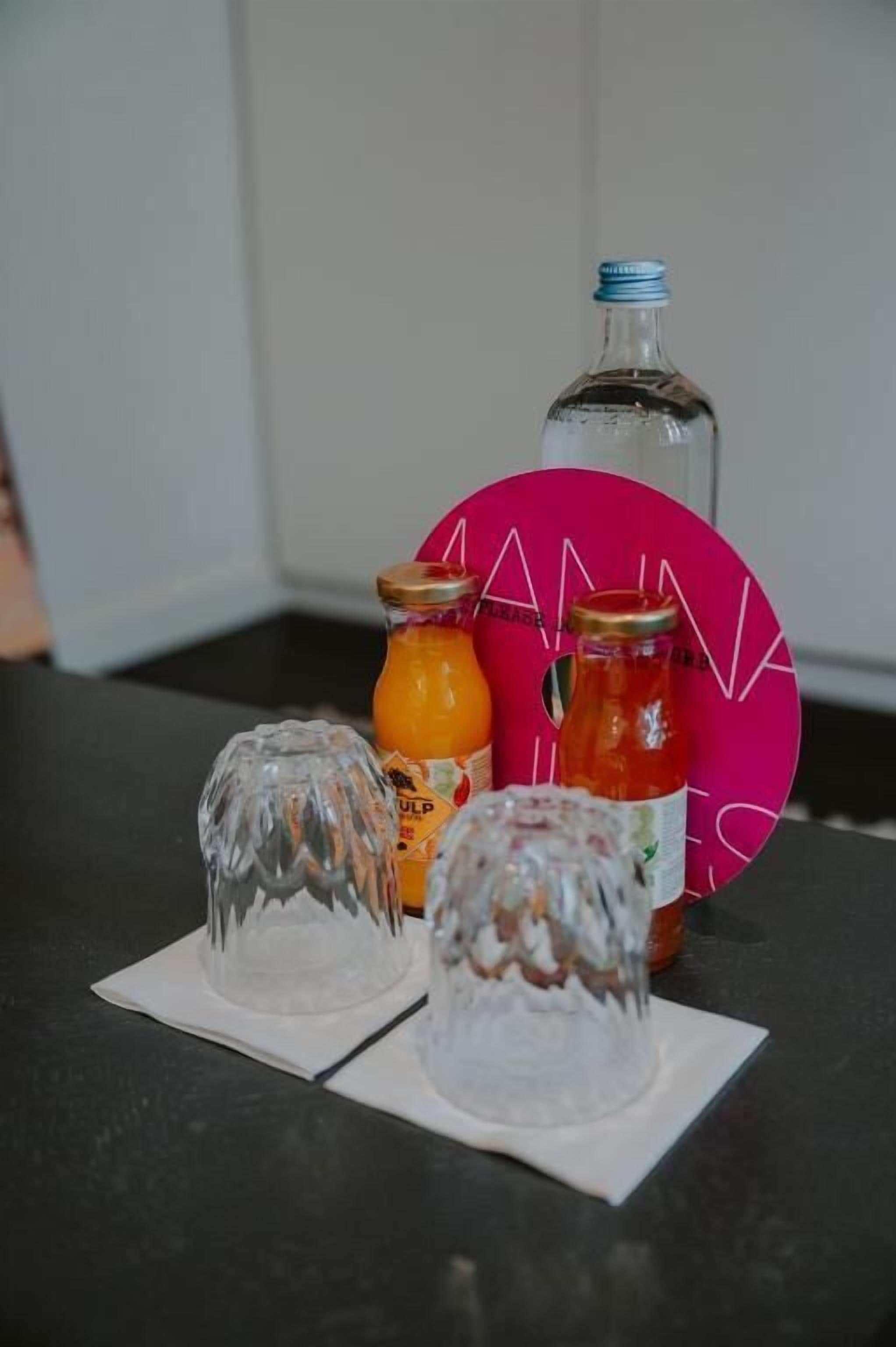 A table with three glass bottles and a pink circular object.
