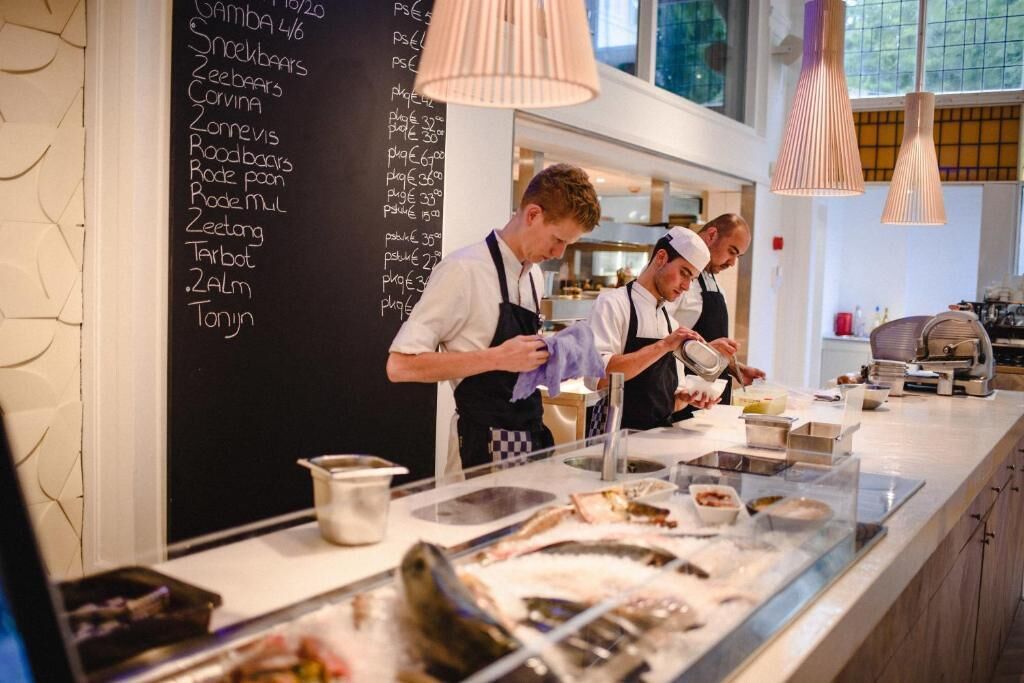 A seafood counter with a menu listing various dishes and prices.