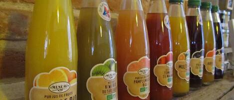 A row of bottles with labels indicating they are organic fruit juices.